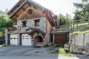 a house with two garages and two garage doors at Lupins in Valloire