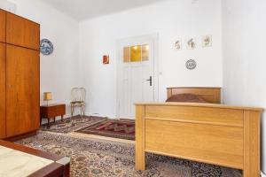 a bedroom with a bed and a dresser and a door at Grosszügiges Ferienhaus mit Wald in Gerdau
