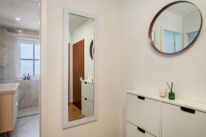 a bathroom with a mirror and a sink at Bodenseenest in Meckenbeuren +12 photos