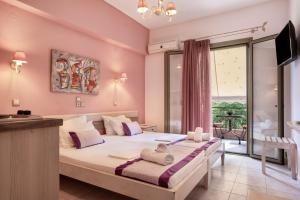 a bedroom with a large bed and a large window at Nontas Home 26 in Kalamitsi