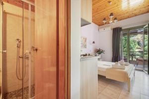 a bathroom with a shower and a bath room at Nontas Homes 36 in Kalamitsi +18 photos