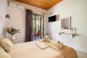 a bedroom with a bed with towels on it at Nontas Homes 36 in Kalamitsi