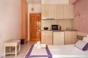 a small room with a bed and a kitchen at Nontas Home 26 in Kalamitsi +16 photos