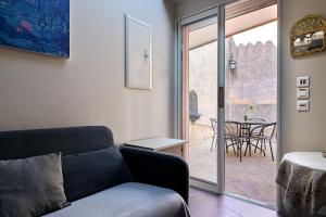 a living room with a couch and a sliding glass door at Les Oliviers in Cassis