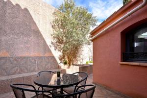 a table and chairs sitting on a patio at Les Oliviers in Cassis
