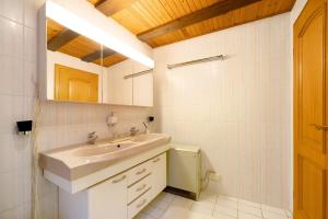a white bathroom with a sink and a mirror at Am Fischertor in Bad Kreuznach +20 photos
