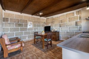 a living room with a table and a tv at Casa Eyden Sunset View in Arona