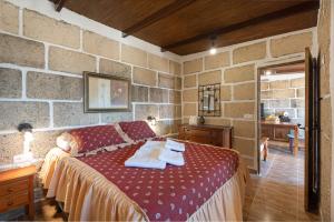 a bedroom with a red bed with towels on it at Casa Eyden Sunset View in Arona