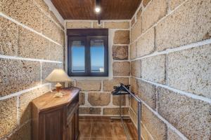 a room with a brick wall and a table with a lamp at Casa Eyden Sunset View in Arona +18 photos