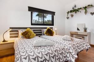 a bedroom with a bed with two pillows on it at Maravilha da Costa in Ponta do Pargo +37 photos