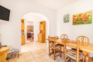 a kitchen and dining room with a table and chairs at Cal Viudet in Caserras
