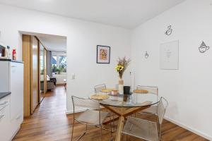 a dining room with a glass table and chairs at Domus Lux 53 in Bad Säckingen