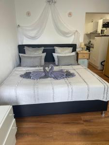 a bedroom with a large bed with white sheets at Domus Lux 53 in Bad Säckingen