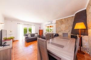 a living room with a table and a couch at Bona Mar in Cala Ratjada