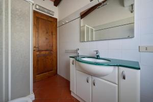 a bathroom with a sink and a mirror at Poggio Diavolino - Suvereto in Suvereto +148 photos