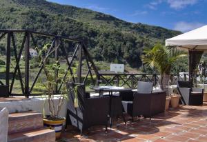 a patio with a table and chairs and a mountain at Aptos Monasterio de San Antonio 1 in Icod de los Vinos +16 photos