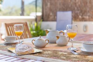 a table with glasses of orange juice and bread on it at Can Joi in Sóller +19 photos
