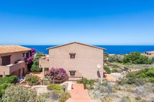 a house with the ocean in the background at Casa Carlotta in Costa Paradiso in Costa Paradiso