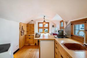 a kitchen with a sink and a counter top at Apartment Zwiefirst in Grafing +44 photos
