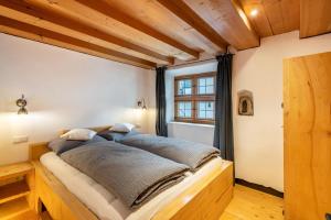 a bed in a room with wooden ceilings at Apartment Zwiefirst in Grafing