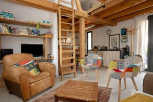 a living room with chairs and a loft bed at Le Balcon des Bauges in La Motte-Servolex