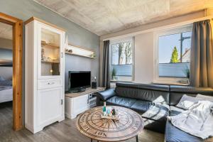 a living room with a couch and a table at Ferienhaus von Osten in Burg