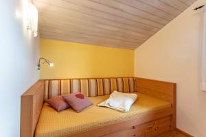 a bed with two pillows on it in a room at Ferienwohnung Geierstein in Wackersberg