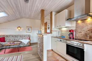 a kitchen and living room with a couch at Ferienwohnung Geierstein in Wackersberg