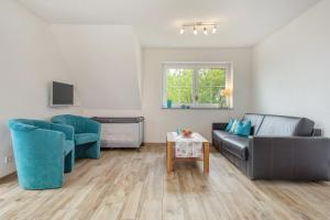 a living room with a couch and two chairs and a table at Biohof Stotz in Friedrichshafen
