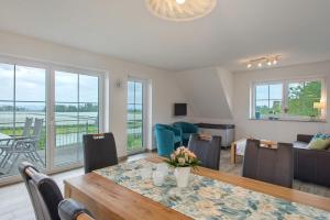 a dining room with a table and a living room at Biohof Stotz in Friedrichshafen