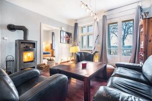 a living room with a couch and a fireplace at Villa Seeblick in Rheinsberg