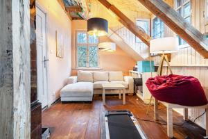 a living room with a couch and a chair at Villa Seeblick in Rheinsberg