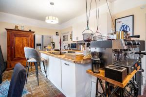 a kitchen with white cabinets and a counter top at Villa Seeblick in Rheinsberg