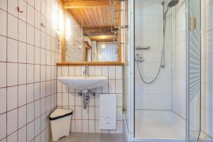 a bathroom with a sink and a shower at Ferienwohnung Spormann in Braunlage +16 photos