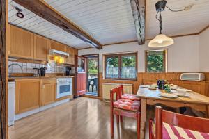 a kitchen with wooden cabinets and a table with chairs at Ferienwohnung Spormann in Braunlage