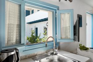 a kitchen with a sink and a window at Politimi Studio N8 in Amorgos +9 photos