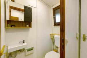 a bathroom with a toilet and a sink at Berghütte in Ulrichstein +18 photos