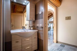 a bathroom with a sink and a mirror at Appartamento Gufo in Tremosine Sul Garda +17 photos