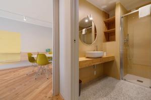 a bathroom with a sink and a glass shower at Palazzo Righi in Carisolo +42 photos