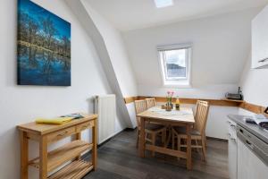 a kitchen with a table and chairs in a room at Schlegelhansenhof in Buchenbach