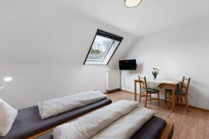 a living room with two beds and a table at Schlegelhansenhof in Buchenbach