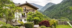 a house on a hill with mountains in the background at Gostnerhof Barbian in Barbiano