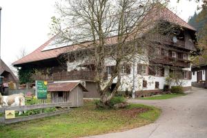 a house with a tree in front of it at Grundhof in Oberprechtal