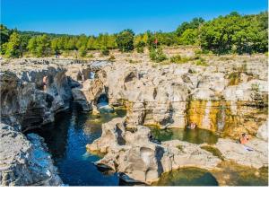a view of a river between two rocky cliffs at Appartement des Cedres in Uzès