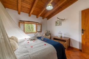a bedroom with a bed with a teddy bear on it at Tenguerengue in Laroya +20 photos