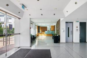 an open lobby with white walls and glass doors at Bay View Albufeira in Albufeira