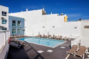 a swimming pool on the side of a building at Bay View Albufeira in Albufeira