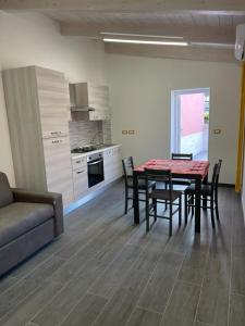 a kitchen and dining room with a table and chairs at Il Paradiso Holiday in Ravenna +8 photos