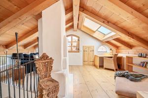 a living room with wooden ceilings and a staircase at Apartment Zwiefirst in Grafing
