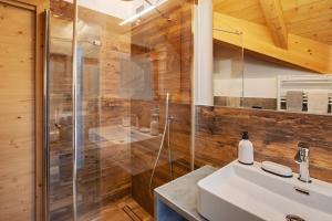 a bathroom with a sink and a shower at Olympic Chalet 12 in Bormio +13 photos